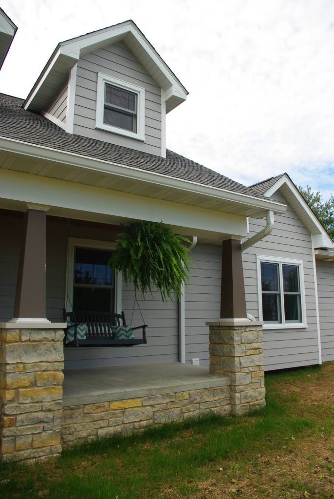 Large farmhouse concrete paver front porch idea in St Louis with a roof extension by Architecturally Designed Cabinetry Inc. | Outdoor Photos | Porch | Landscaping | Landscape Design | Outdoor Living Space | Porch Design Ideas | Outdoor Living Space Ideas | Backyard Design