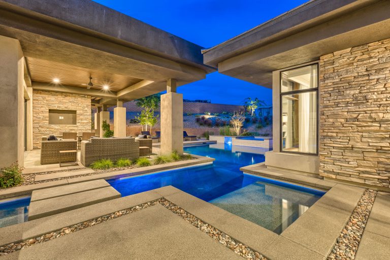 Large minimalist backyard concrete paver and custom-shaped lap hot tub photo in Las Vegas