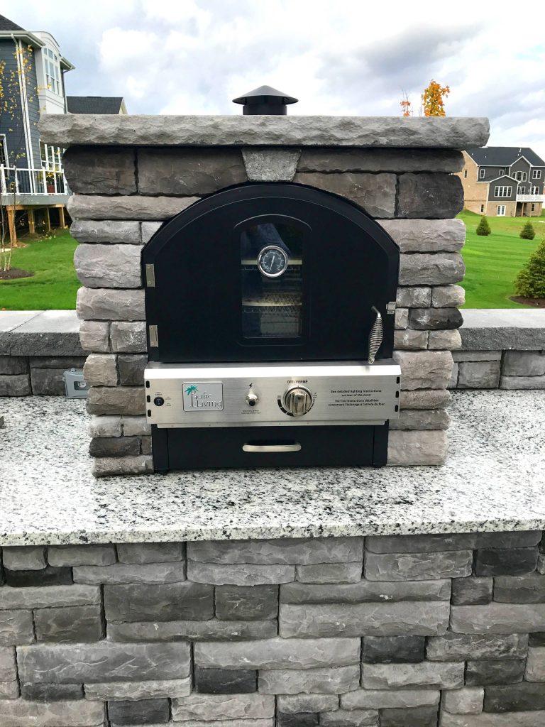 Large minimalist backyard concrete paver patio kitchen photo in Other with no cover