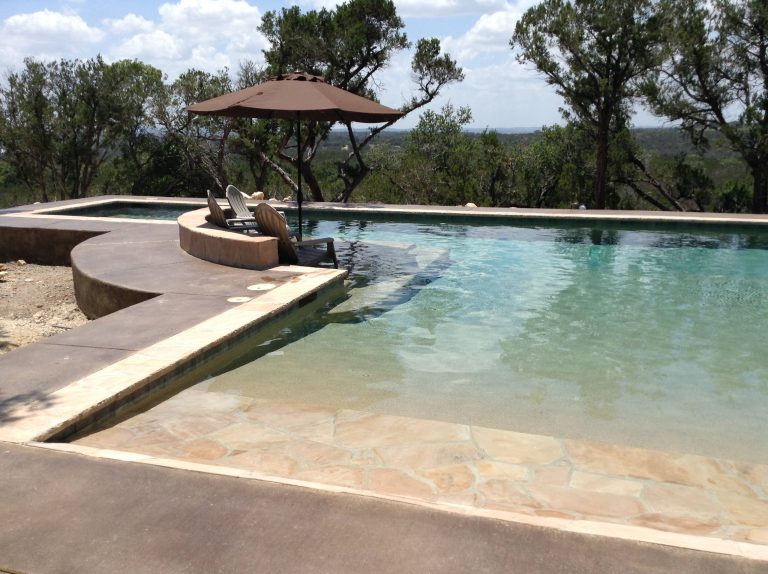 Large minimalist backyard custom-shaped lap hot tub photo in Austin with decking
