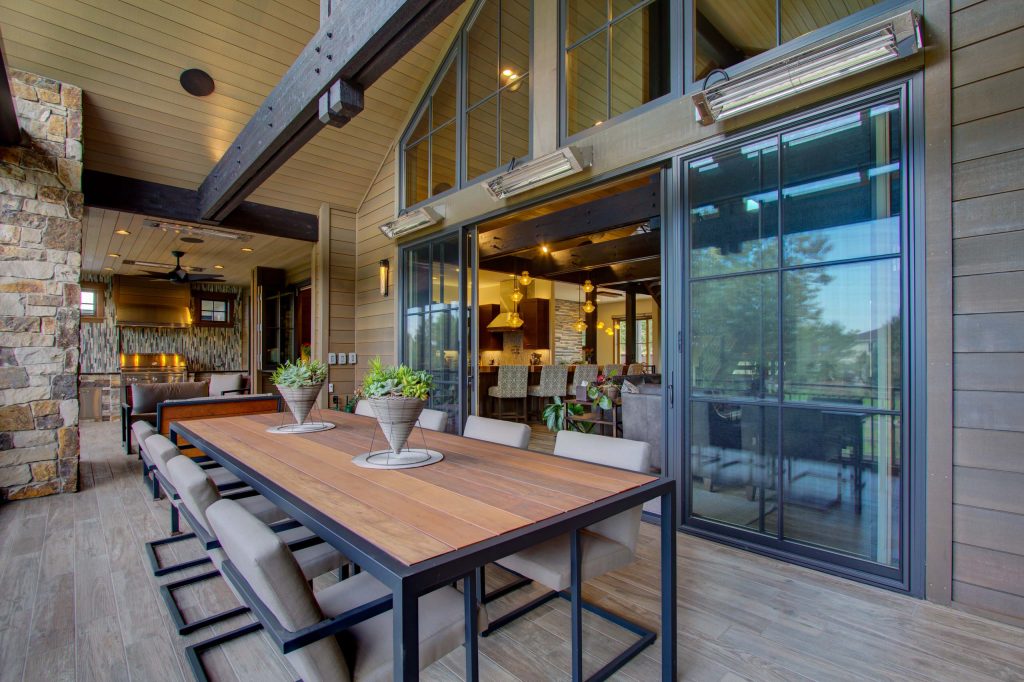 Large minimalist backyard outdoor kitchen deck photo in Denver with a roof extension