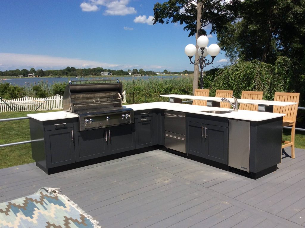 Large minimalist backyard patio kitchen photo in New York with decking and no cover