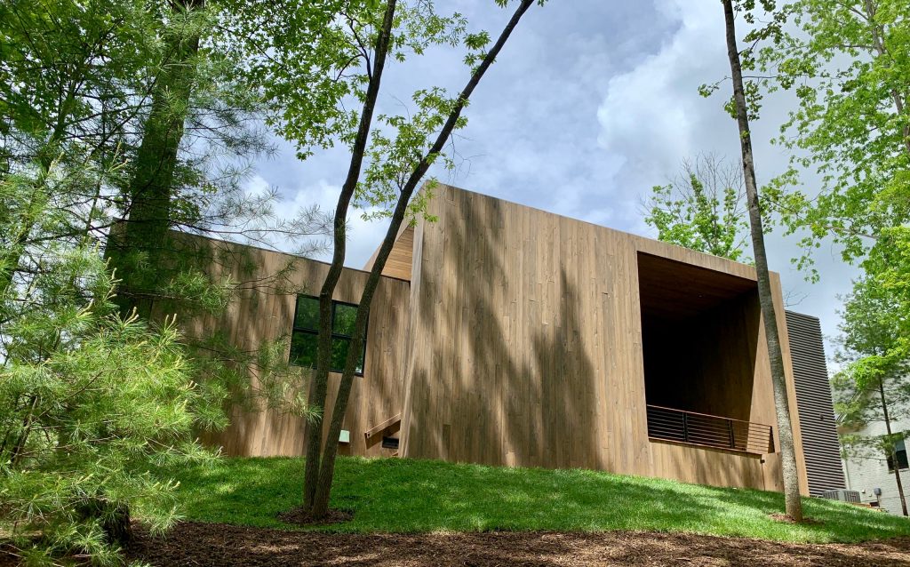 Large minimalist stone back porch idea in Other with a fire pit and a roof extension by ROOST - home design | cabinetry | interiors | Outdoor Photos | Porch | Landscaping | Landscape Design | Outdoor Living Space | Porch Design Ideas | Outdoor Living Space Ideas | Backyard Design