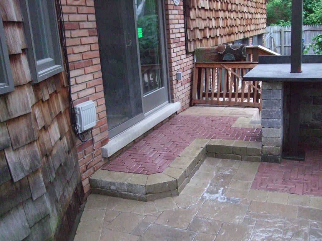 Large mountain style backyard brick patio kitchen photo in Detroit with a pergola