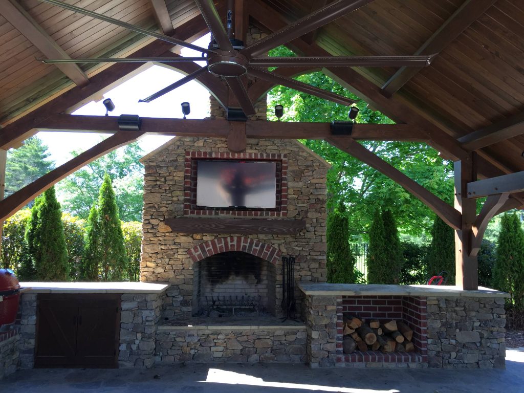 Large mountain style backyard concrete paver patio kitchen photo in Other with a gazebo