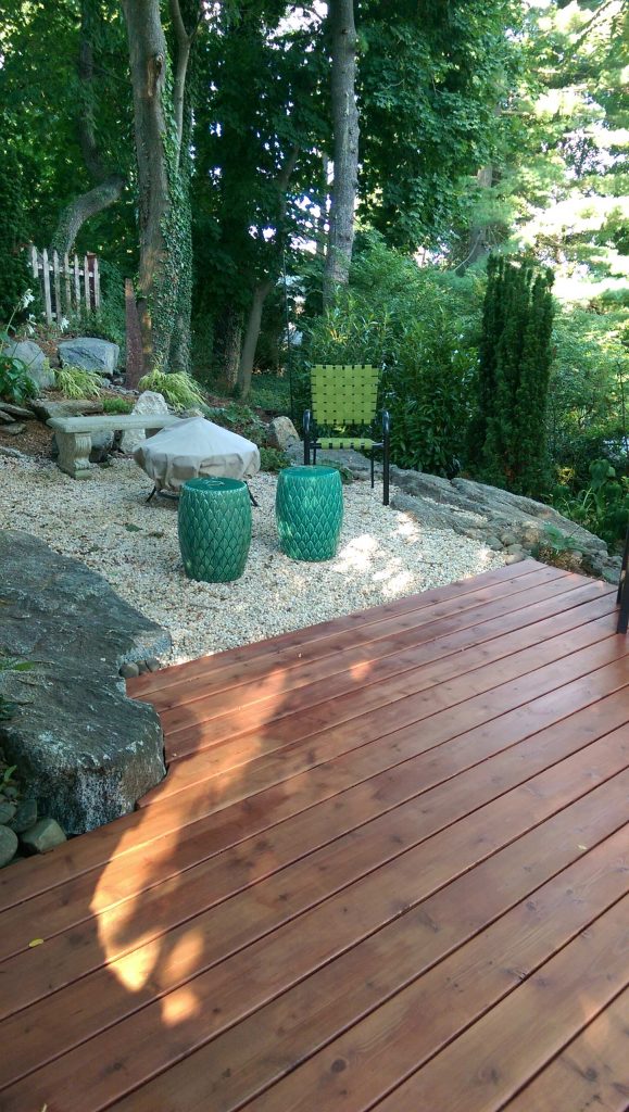 Large mountain style backyard outdoor kitchen deck photo in New York with no cover