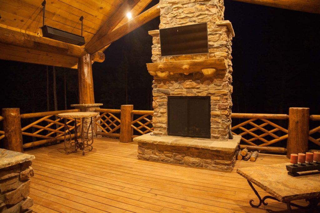 Large mountain style backyard patio kitchen photo in Albuquerque with decking and a roof extension