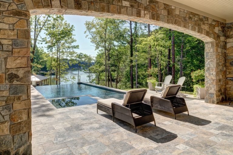 Large mountain style backyard rectangular and stone infinity hot tub photo in Charlotte
