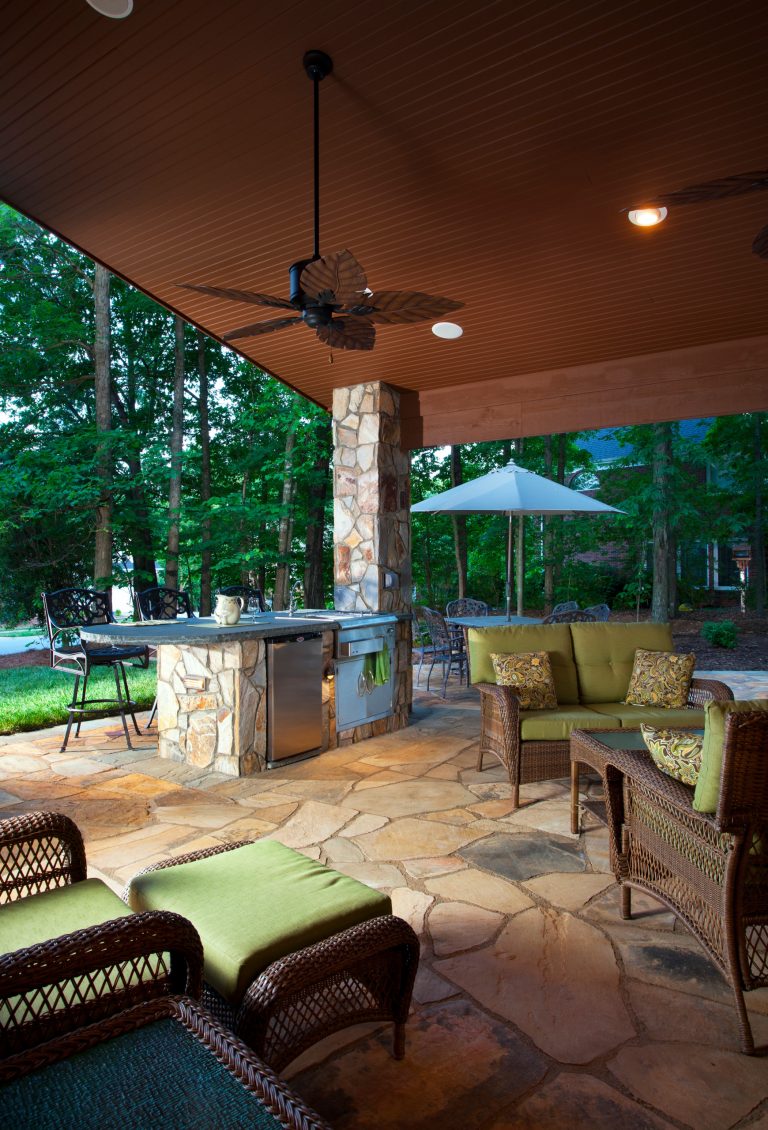 Large mountain style backyard stone patio kitchen photo in Charlotte with a gazebo