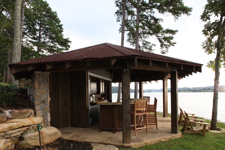 Large mountain style backyard stone patio kitchen photo in Other with a gazebo