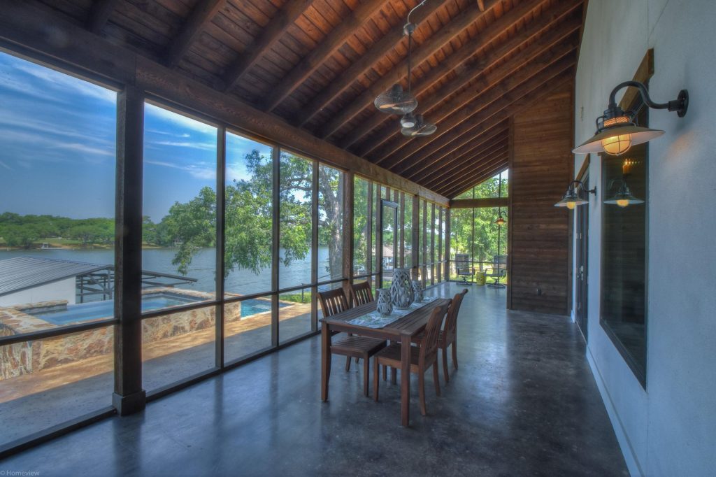 Large mountain style concrete screened-in back porch photo in Austin with a roof extension by Delineations, Inc. | Outdoor Photos | Porch | Landscaping | Landscape Design | Outdoor Living Space | Porch Design Ideas | Outdoor Living Space Ideas | Backyard Design