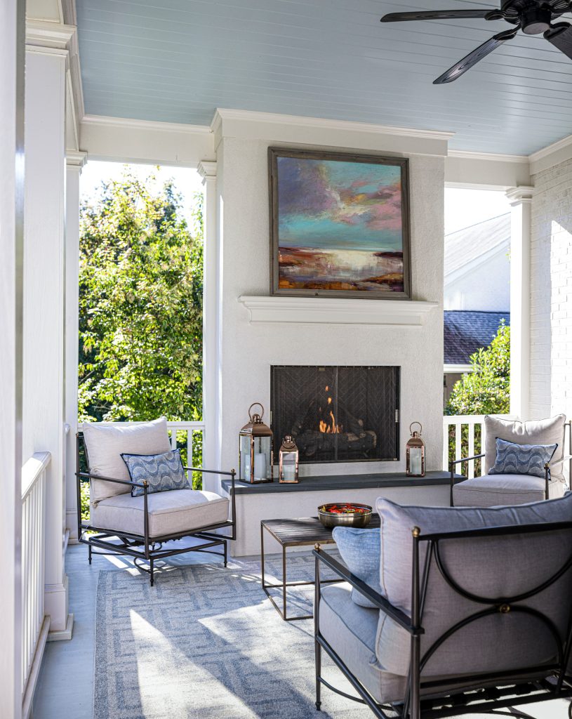 Large outdoor covered porch with built-in gas fireplace.