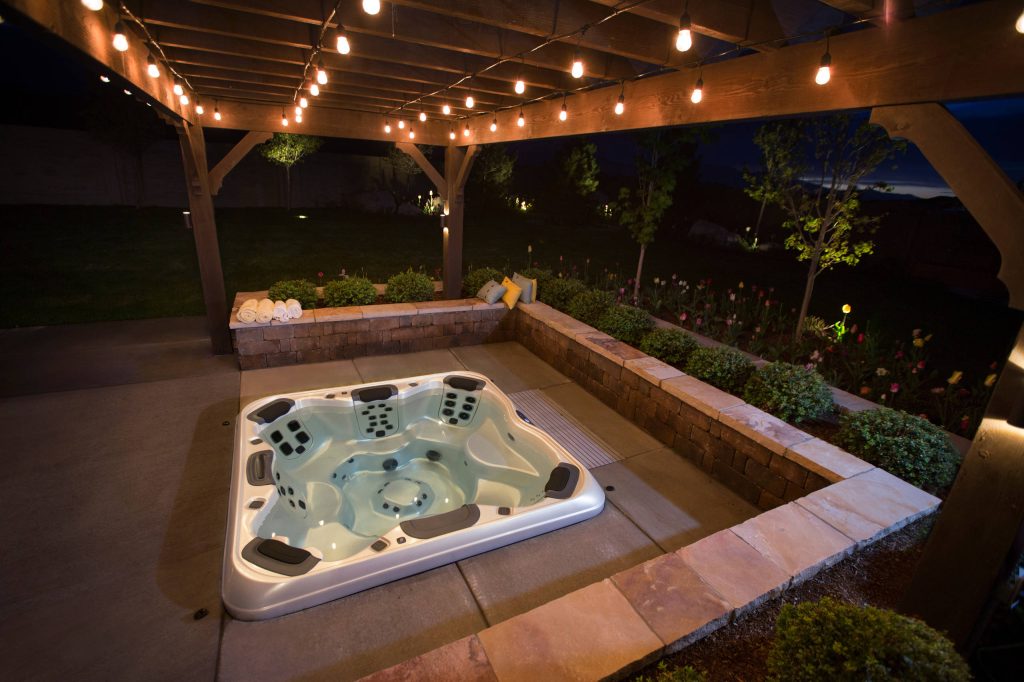 Large transitional backyard concrete paver and rectangular lap hot tub photo in Salt Lake City
