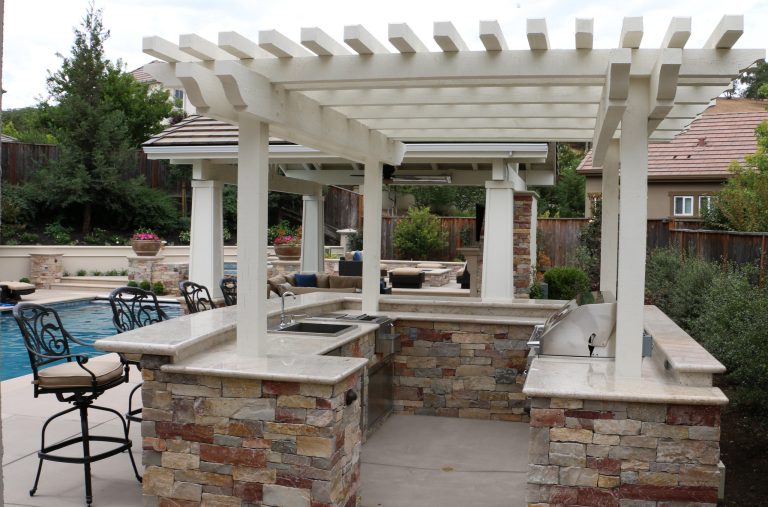 Large transitional backyard concrete paver patio kitchen photo in San Francisco with a pergola