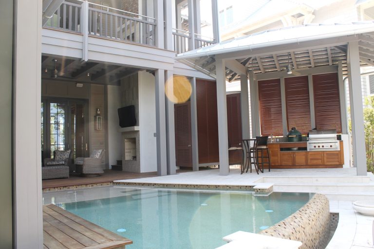 Large transitional backyard patio kitchen photo in Miami with decking and a roof extension