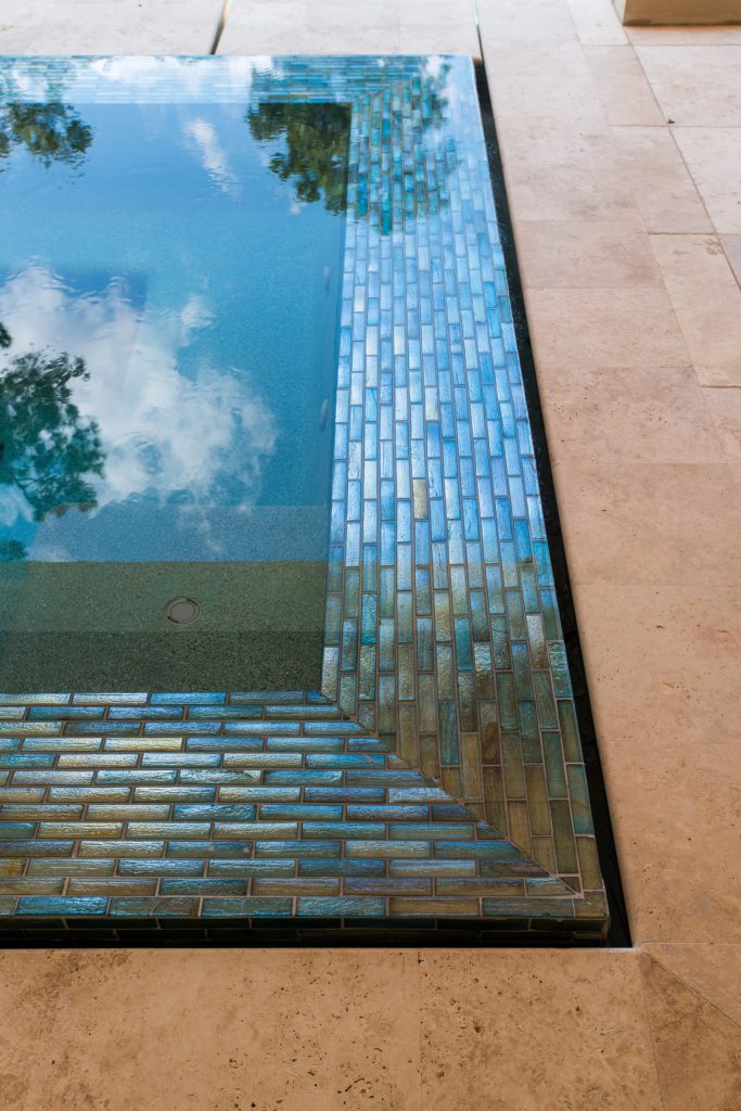 Large transitional backyard stone and rectangular infinity hot tub photo in Houston