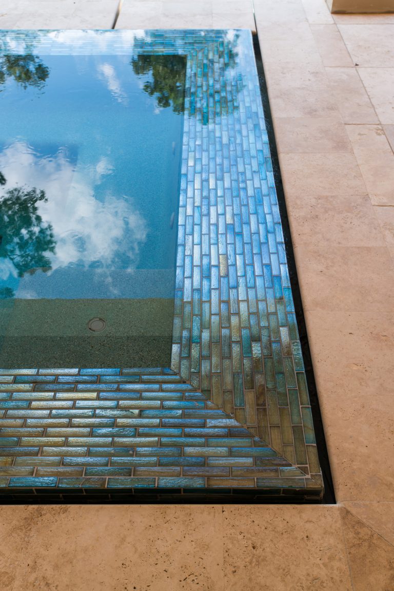 Large transitional backyard stone and rectangular infinity hot tub photo in Houston