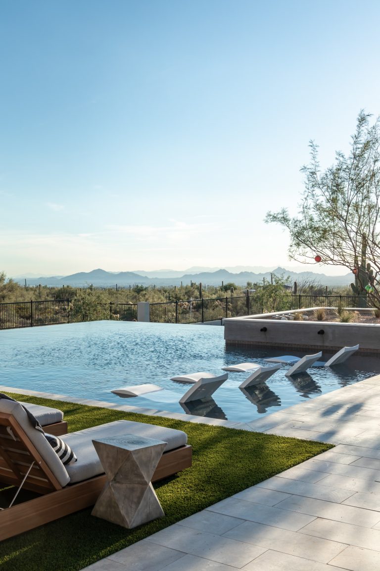 Large transitional backyard stone and rectangular infinity hot tub photo in Phoenix