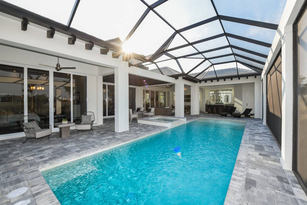 Large transitional backyard stone and rectangular lap pool photo in Tampa