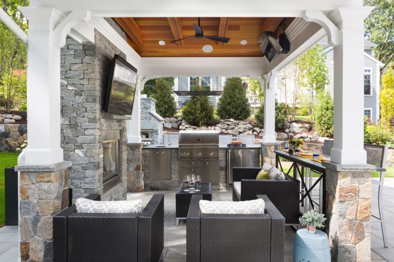 Large transitional backyard stone patio kitchen photo in Boston with a gazebo