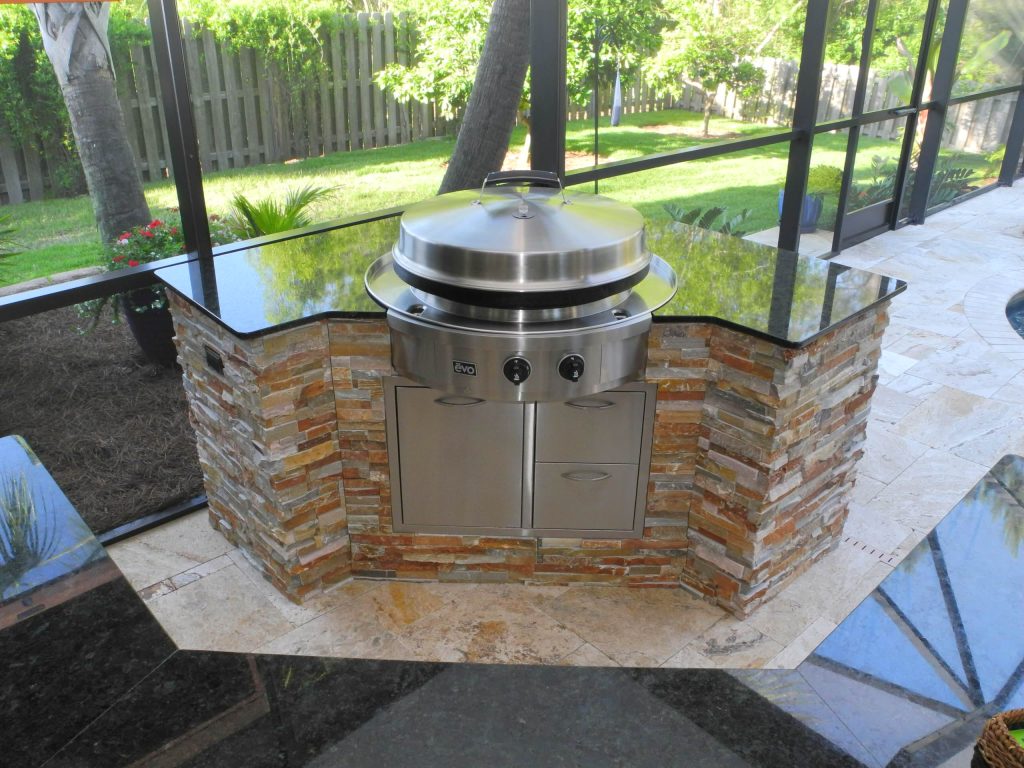 Large transitional backyard tile patio kitchen photo in Jacksonville with an awning