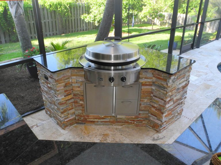 Large transitional backyard tile patio kitchen photo in Jacksonville with an awning