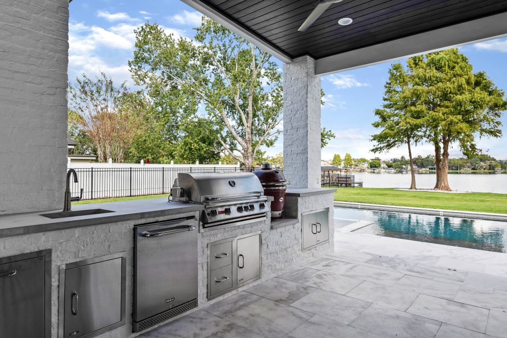 Large transitional backyard tile patio kitchen photo in Orlando with a roof extension