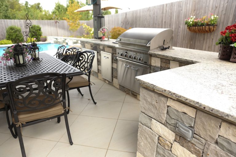 Large transitional backyard tile patio kitchen photo in Other with a gazebo
