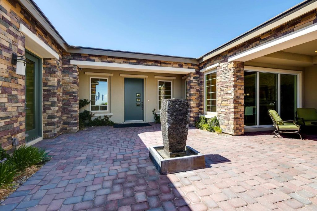Large transitional brick porch photo in Las Vegas with a roof extension by Touchstone Living | Outdoor Photos | Porch | Landscaping | Landscape Design | Outdoor Living Space | Porch Design Ideas | Outdoor Living Space Ideas | Backyard Design