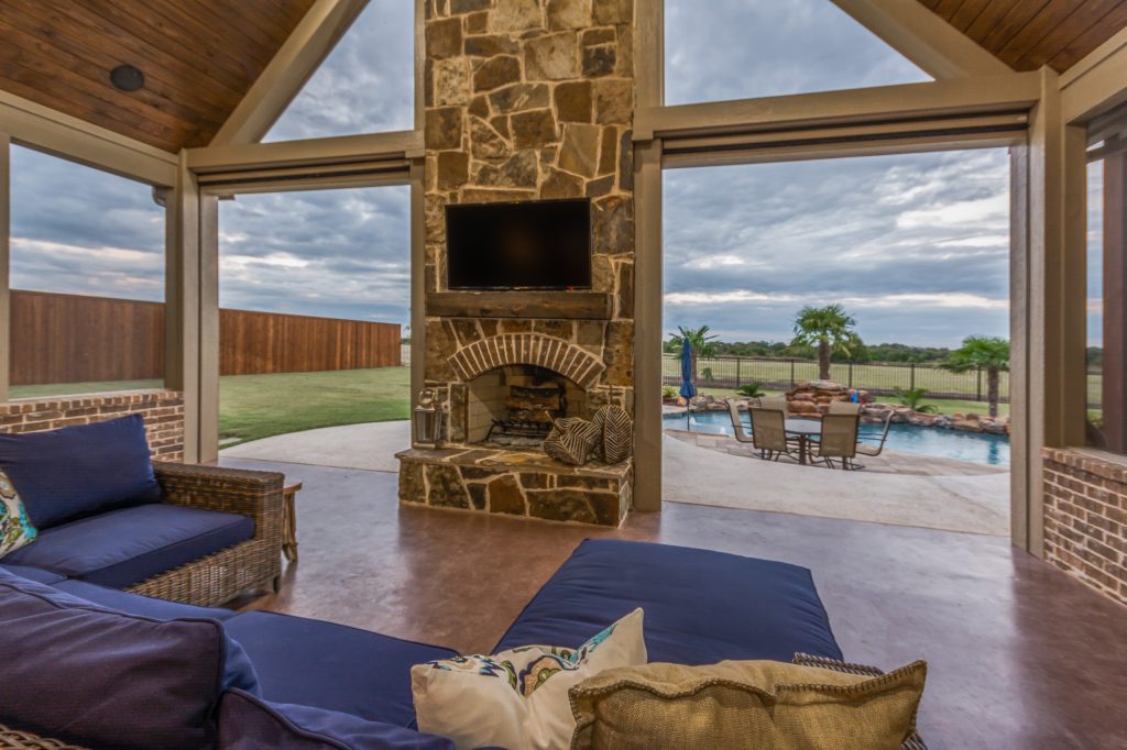 Large transitional concrete back porch idea in Dallas with a roof extension by Troy Miller Custom Homes | Outdoor Photos | Porch | Landscaping | Landscape Design | Outdoor Living Space | Porch Design Ideas | Outdoor Living Space Ideas | Backyard Design