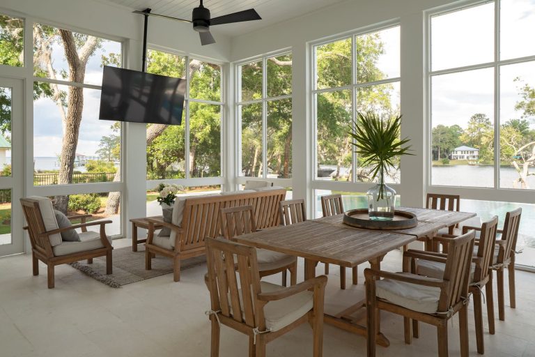 Large transitional concrete paver screened-in and wood railing back porch photo in Other with a roof extension by Geoff Chick & Associates | Outdoor Photos | Porch | Landscaping | Landscape Design | Outdoor Living Space | Porch Design Ideas | Outdoor Living Space Ideas | Backyard Design