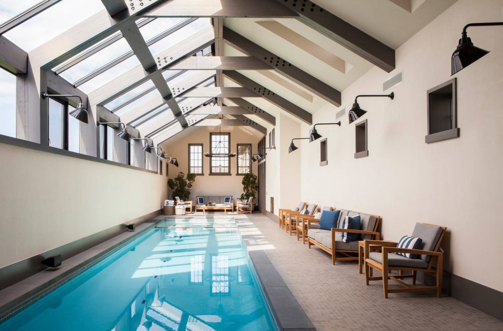 Large transitional indoor tile and rectangular lap pool photo in New York