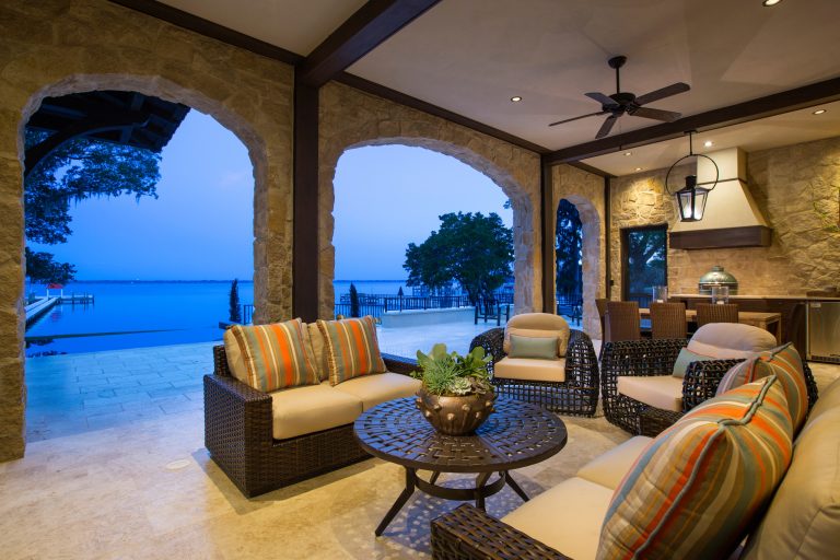 Large transitional tile porch idea in Jacksonville with an awning