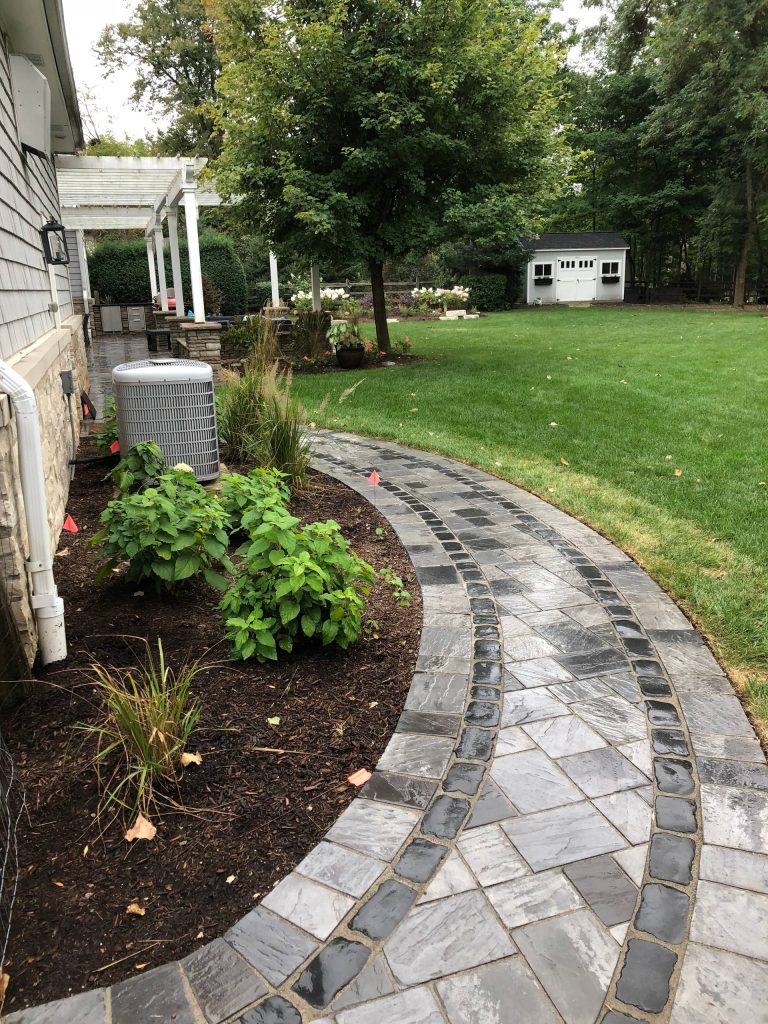 Large trendy backyard brick patio kitchen photo in Chicago with a pergola