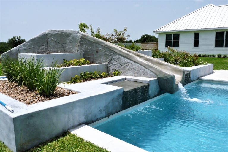 Large trendy backyard concrete and rectangular water slide photo in Houston