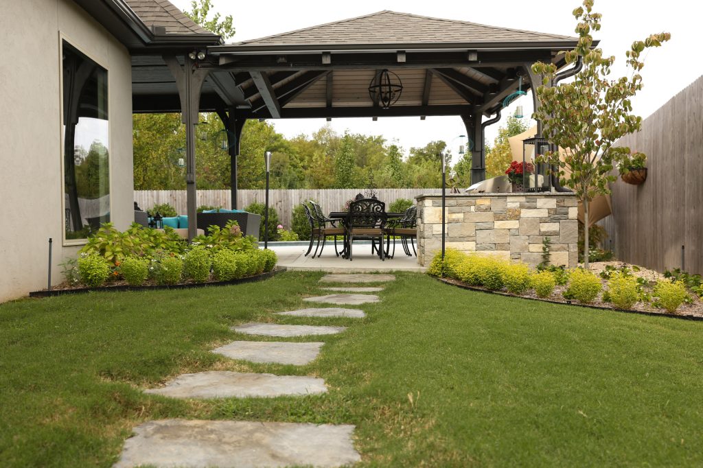 Large trendy backyard concrete patio kitchen photo in Other with a pergola
