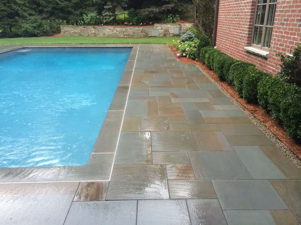 Large trendy backyard concrete paver and custom-shaped lap pool fountain photo in New York