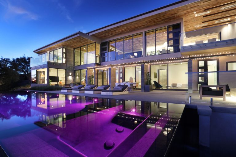 Large trendy backyard concrete paver and rectangular infinity hot tub photo in Orange County