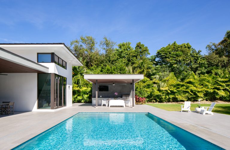 Large trendy backyard concrete paver and rectangular lap pool house photo in Miami