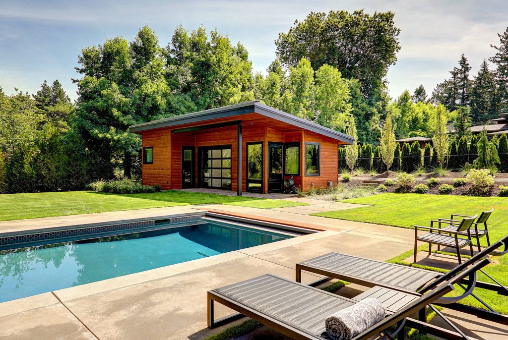 Large trendy backyard concrete paver and rectangular lap pool house photo in Portland