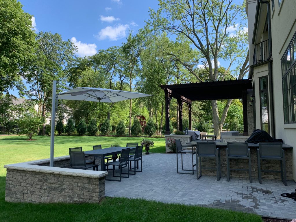Large trendy backyard concrete paver patio kitchen photo in Chicago with a pergola