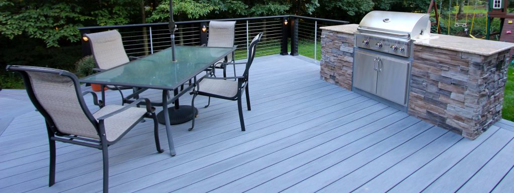 Large trendy backyard outdoor kitchen deck photo in Other with no cover