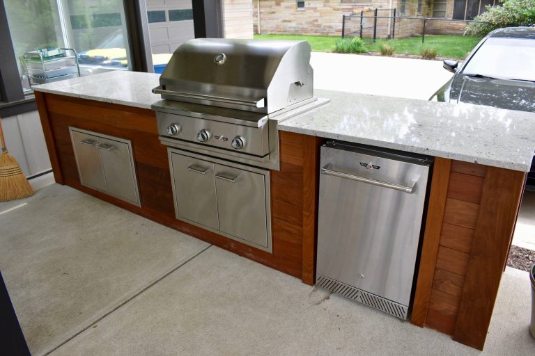 Large trendy backyard patio kitchen photo in Indianapolis with decking and a pergola