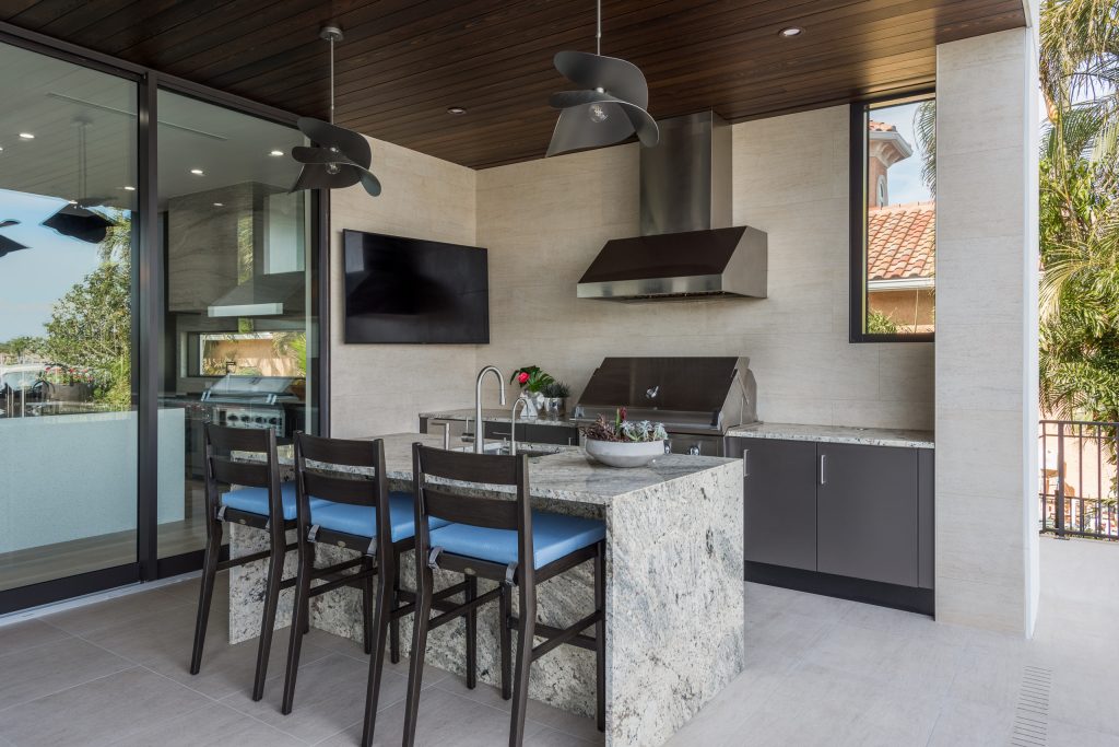 Large trendy backyard patio kitchen photo in Tampa with a roof extension