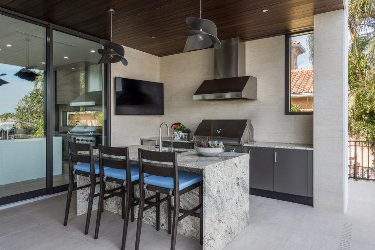 Large trendy backyard patio kitchen photo in Tampa with a roof extension