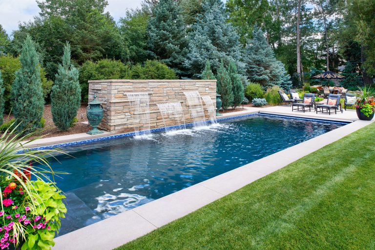 Large trendy backyard rectangular lap pool fountain photo in Denver