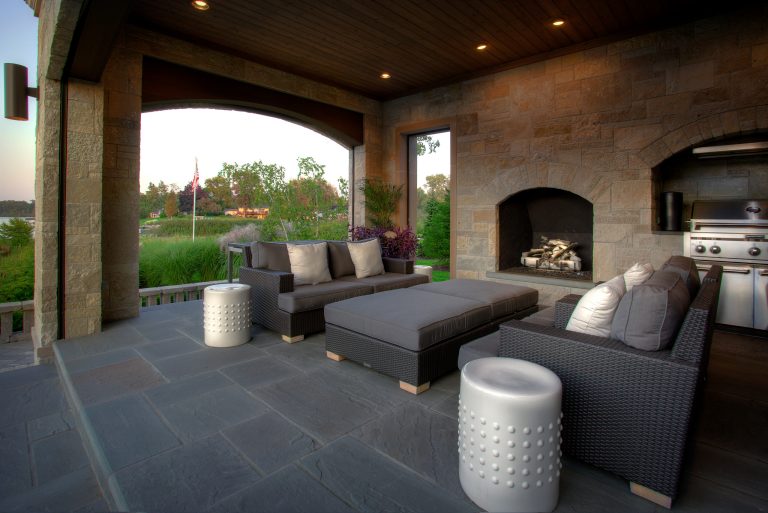 Large trendy backyard stone patio kitchen photo in Detroit with a roof extension