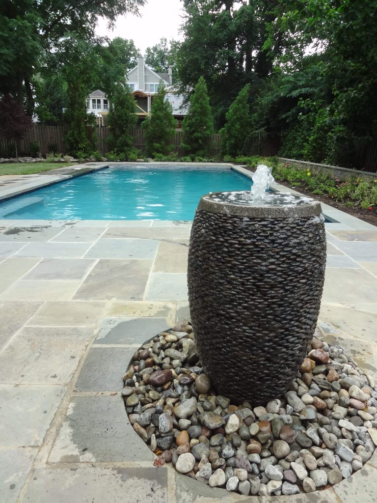 Large trendy backyard tile and rectangular lap pool fountain photo in DC Metro