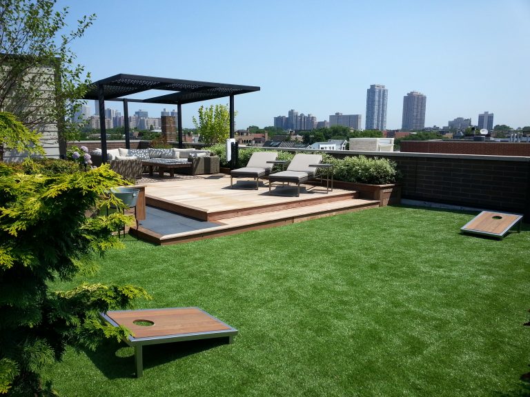 Large trendy rooftop deck photo in Chicago with a pergola