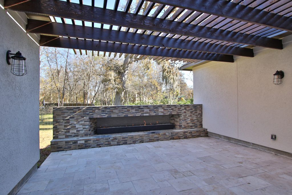 Large trendy tile side porch photo in Houston with a fire pit and a pergola by Makena Custom Builders | Outdoor Photos | Porch | Landscaping | Landscape Design | Outdoor Living Space | Porch Design Ideas | Outdoor Living Space Ideas | Backyard Design